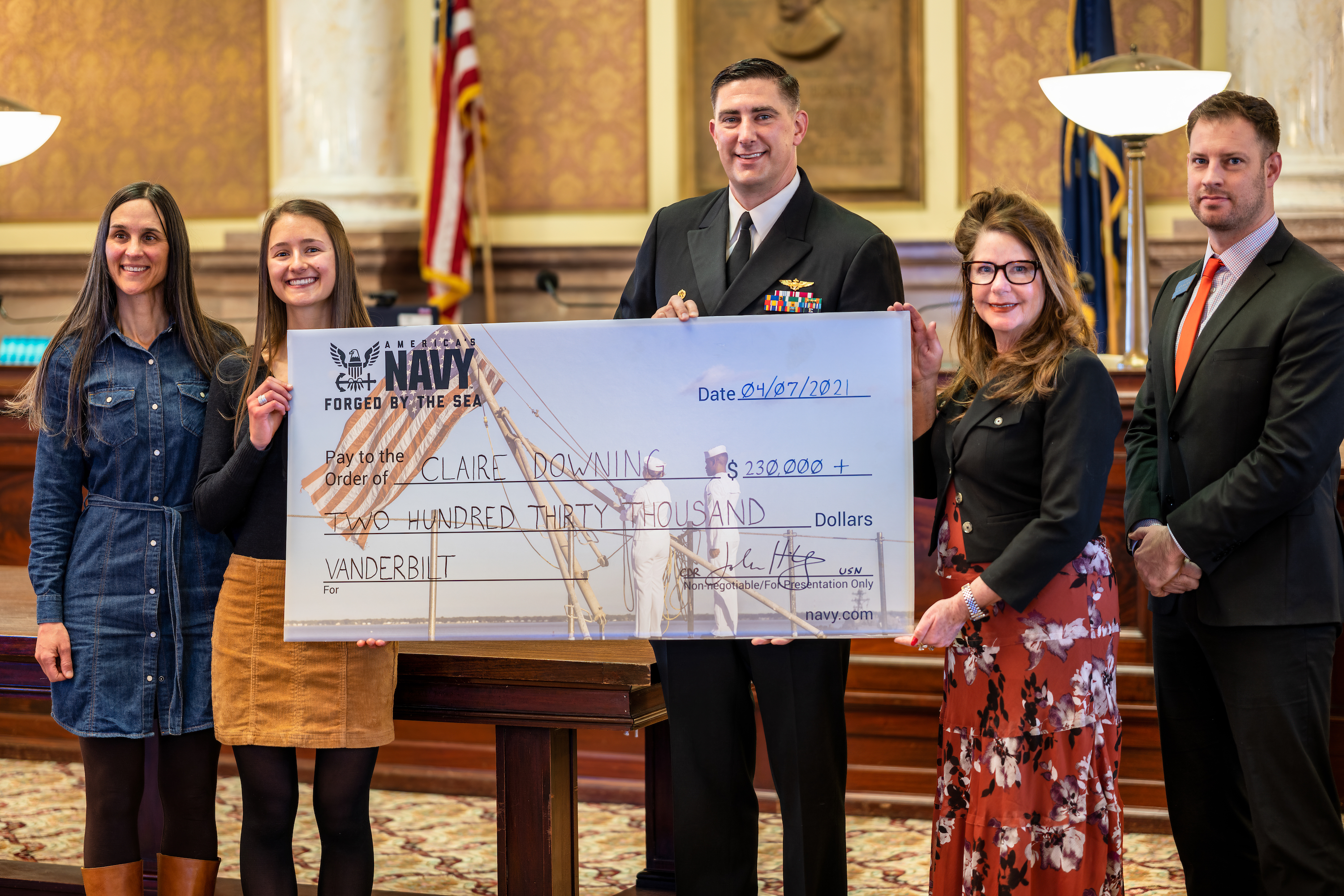 Claire Downing pictured with mother, Superintendent Elsie Arntzen, and  CDR John Hiltz, United States Navy Commanding Office, Navy Talent Acquisition Group Pacific Northwest